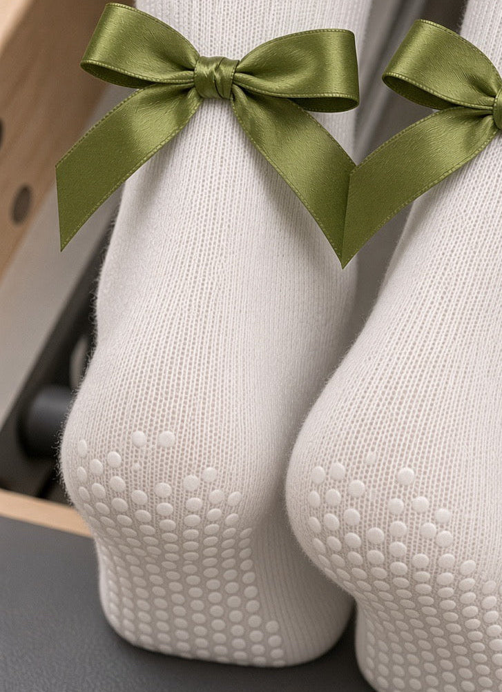 Olive satin bows on the heels of grip socks